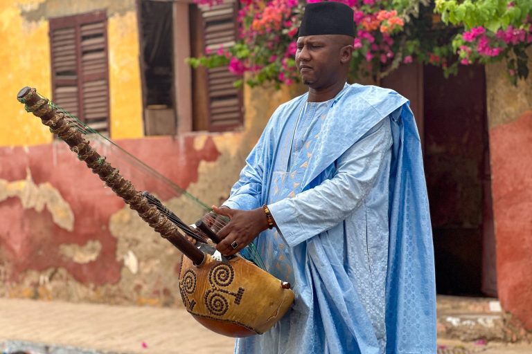 man playing kora